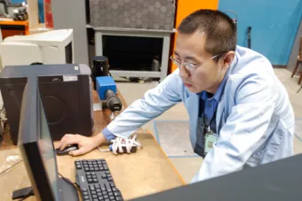 researcher interacting with computer screen